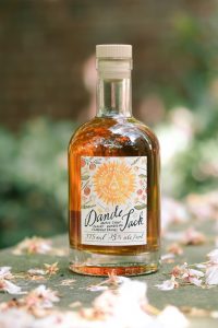 Dande Jack Maple Syrup Chicory Dandelion Flavored Brandy close-up on pavement