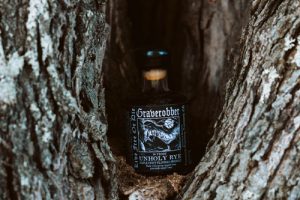 Graverobber bottle peeking from inside tree.