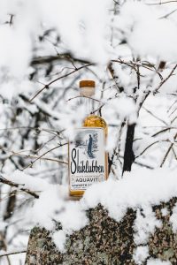 Skiklubben bottle in snow.