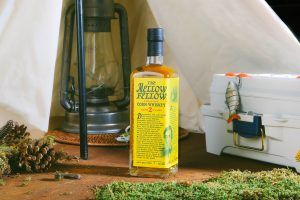Mellow Fellow Corn Whiskey with camping props.