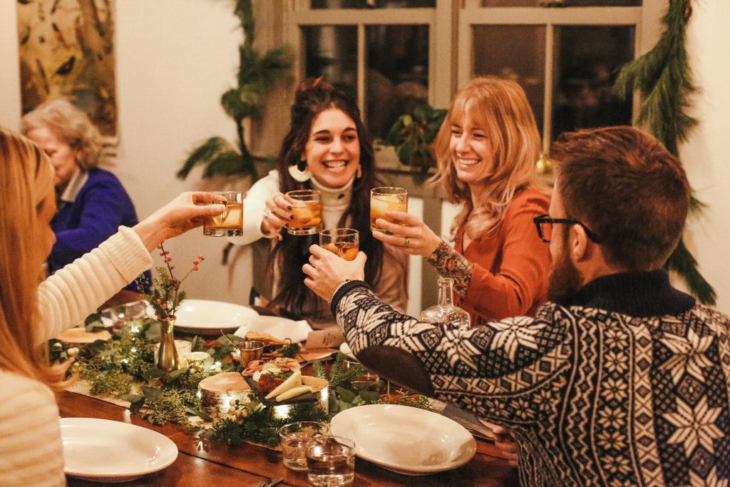 Group of friends saying cheers. Holiday decor.