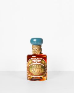 Crab Trapper Green Crab Flavored Whiskey on white.